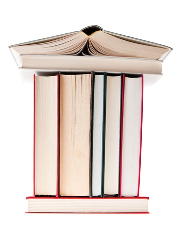 This is a photograph of a stack of books arranged like a house.